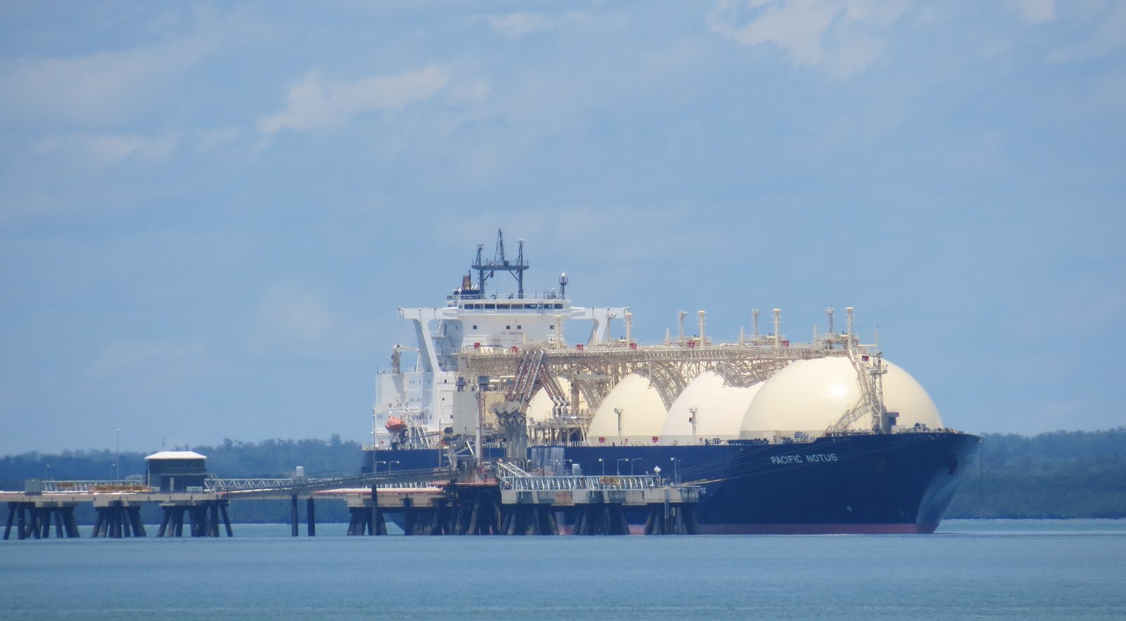 LNG tanker with white spherical tanks at a loading jetty — liquefied natural gas cargo